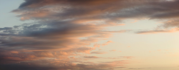 Naklejka na ściany i meble sunset over the sea, with light orange clouds