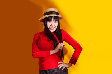 girl hat sun light shadow tropical yellow orange young woman background red dress tropic