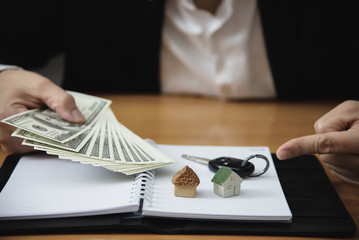 Fototapeta premium Business man show money bank note make financial plan invite people to sell or buy house and car - monetary properties loan credit insurance concept