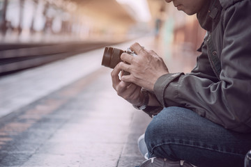Travel man wait train at platform - people vacation lifestyle activities at train station transportation concept