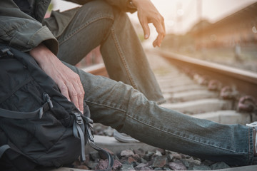 Travel man wait train at platform - people vacation lifestyle activities at train station transportation concept