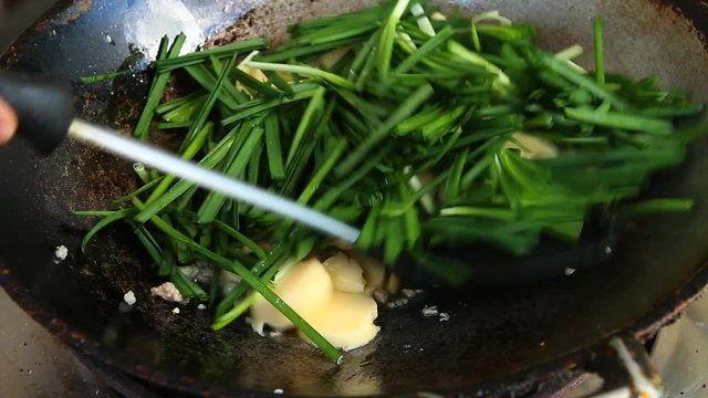 Frying tofu with garlic chives in pan , Chiangmai Thailand