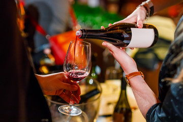 pouring wine from the bottle into the glass wine testing event image detail with blurry background