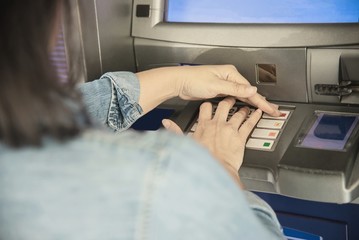 People waiting to get money from automated teller machine - people withdrawn money from ATM concept
