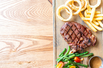 medium rare beef steak with vegetable and french fries