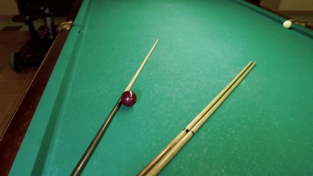 Men playing billiards, hitting the balls with a cue into pockets on a billiard table. 4K