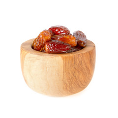 dried sweet dates fruits in wooden cup isolated on white