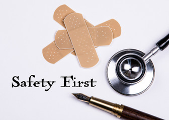 Safety First. Set of adhesive plasters and stethoscope on white background. First aid and home help