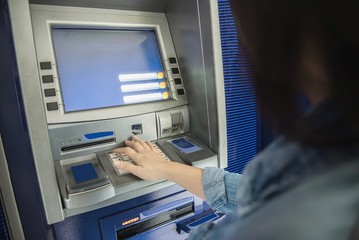 People waiting to get money from automated teller machine - people withdrawn money from ATM concept
