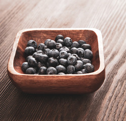 ripe sweet blueberries on wooden table