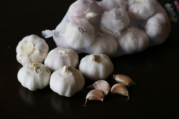 Garlic bulbs on black background