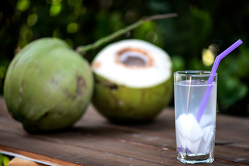 coconut juice in glass on wooden floor