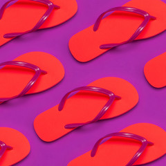 Pattern from Coral flip flops on purple background. Flat lay, top view. Creative Summer Vacation...