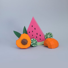 Paper peach and watermellon on grey background