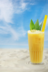 Cold fresh fruit summer cocktail by beach