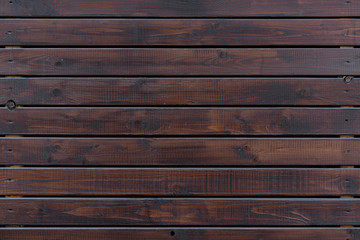 natural wood texture, horizontal boards. Exterior finish of the building with wood. Brown.