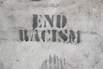Black stencil on grey wall, outdoors