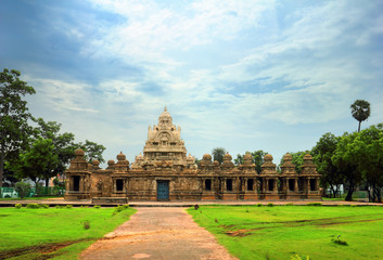 Fototapeta na wymiar Beautiful scenic view of ancient Hindu Kailasanathar Temple (popular tourist and pilgrim attraction) against the background of cloudy blue sky in Kanchipuram, Tamil Nadu, Southern India