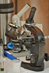 Microscope at a school scientific exhibition. Experiments on chemistry and biology with microscopes. School and student equipment.