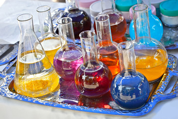 Glass tubes with a multicolored liquid. Demonstration of experiments on chemistry and biology at the school scientific exhibition.