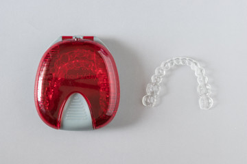 Top view of invisalign braces or invisible retainers on grey background, new orthodontic equipment