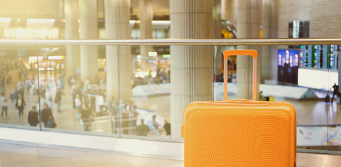Suitcase in airport airport terminal waiting area with arrival zone as a background. Traveling...