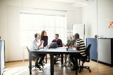 Smiling designers working on a project together in an office