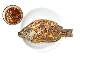 batter fried mango fish topping chop garlic on plate dipping sweet tamarind sauce