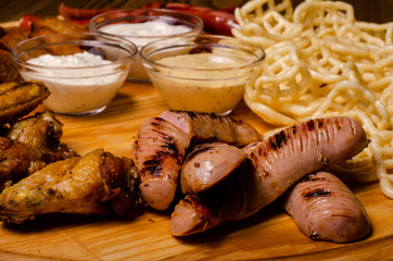 Tasty grilled steak with beer on cutting board.