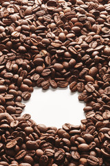 Heap of coffee beans with an opening in the middle for text