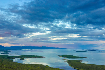 Aerial panorama view of Colorful sunset landscape on the coast of the North Sea. Karelian pine on the rocks on the shore of the White Sea. Coast Murmansk region, Kandalaksha Nature Reserve.