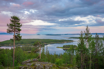Fototapeta na wymiar Aerial view of Colorful sunset landscape on the coast of the North Sea. Karelian pine on the rocks on the shore of the White Sea. Coast Murmansk region, Kandalaksha Nature Reserve.