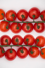Fresh Cherry tomatoes on branch - isolated on white background.