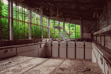 Old empty school swimming pool in destroyed abandoned ghost city Pripyat ruins after Chernobyl...