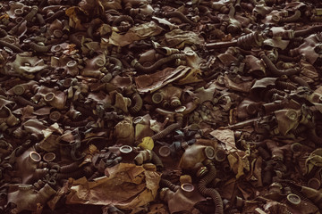 Gas masks, respirator in destroyed abandoned ghost city Pripyat ruins after Chernobyl disaster. Chernobyl Nuclear Power Plant atomic reactor explosion. Exclusion zone radiation risk background.