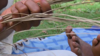 Extreme close-up high-angle still shot of a craftsperson arranging dry slender straws for weaving traditional hats, Cusco, Peru