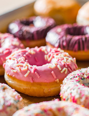 Assorted sweet donuts in a paper box.