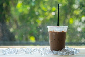 Glass of ice cocoa with drinking straw