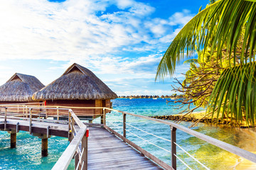 View of the bungalow on the sandy beach, Bora Bora, French Polynesia. - obrazy, fototapety, plakaty