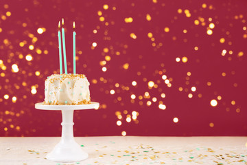 Birthday cake with candles with bokeh lights. Birthday party celebration concept. Horizontal, bold red background