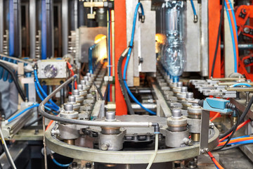 A closeup of a plastic bottle production