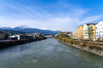 Fototapeta na wymiar Innsbruck, Tyrol, Austria. Colored houses on the Inn River in Innsbruck. Colored houses in Innsbruck.