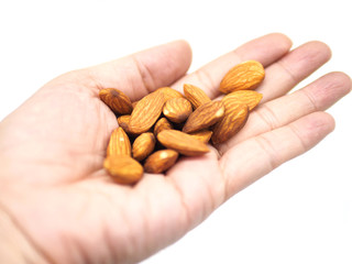 hand with almonds isolated on white background