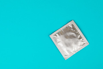 Condom on a blue background. The concept of safe sex.