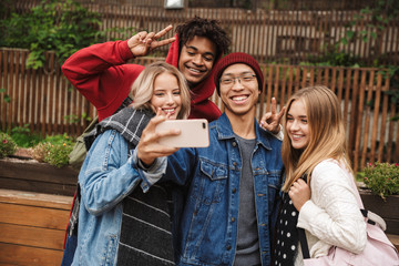 Group if cheerful multiethnic friends teenagers