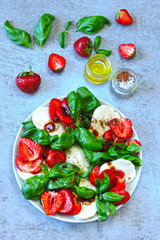 Caprese salad with strawberries. Strawberry salad with basil and mozzarella. Healthy summer salad. Keto summer. Keto diet.