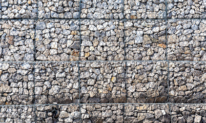 Stone wall with metal grid as background