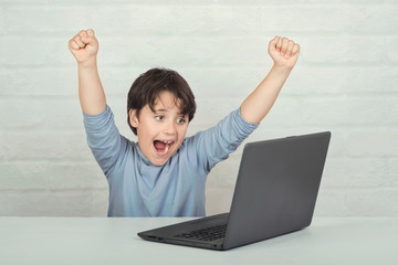 Happy child with laptop computer
