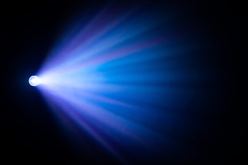 blue purple spotlight projector on abstract smoke texture . glowing screening for cinematography...