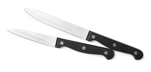 Stainless steel knives on white background, top view